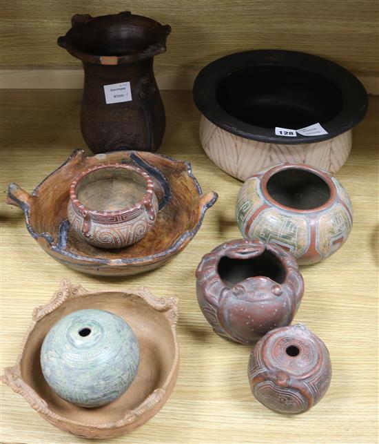 A collection of Brazilian incised terracotta and carved wood bowls and vases diameter 29cm